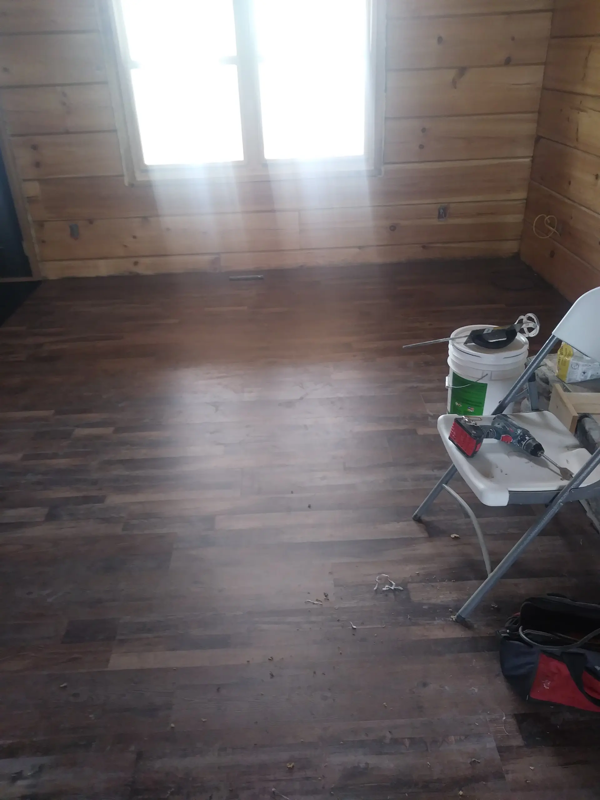 Dark vinyl plank floor installation in progress