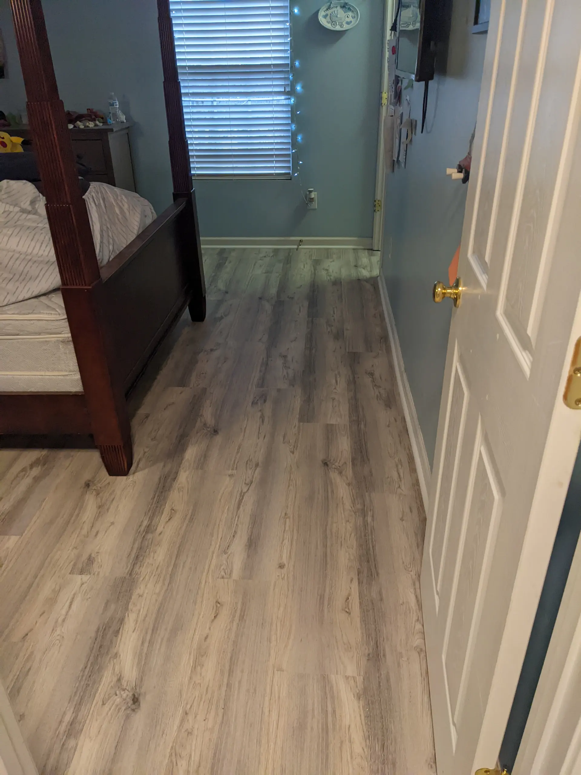 Gray oak laminate flooring from bedroom into hallway