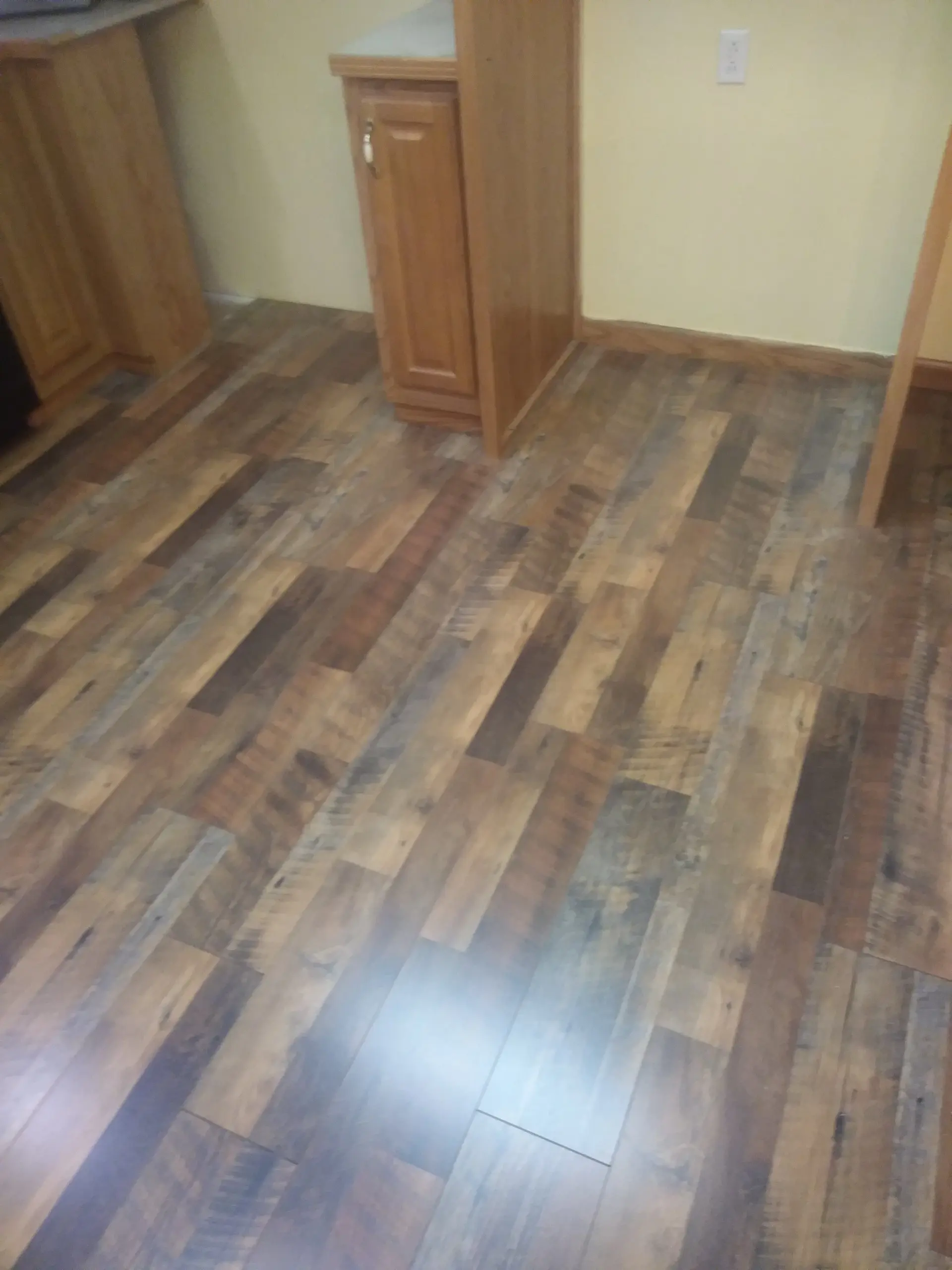 Multi-tone reclaimed look laminate flooring through a doorway