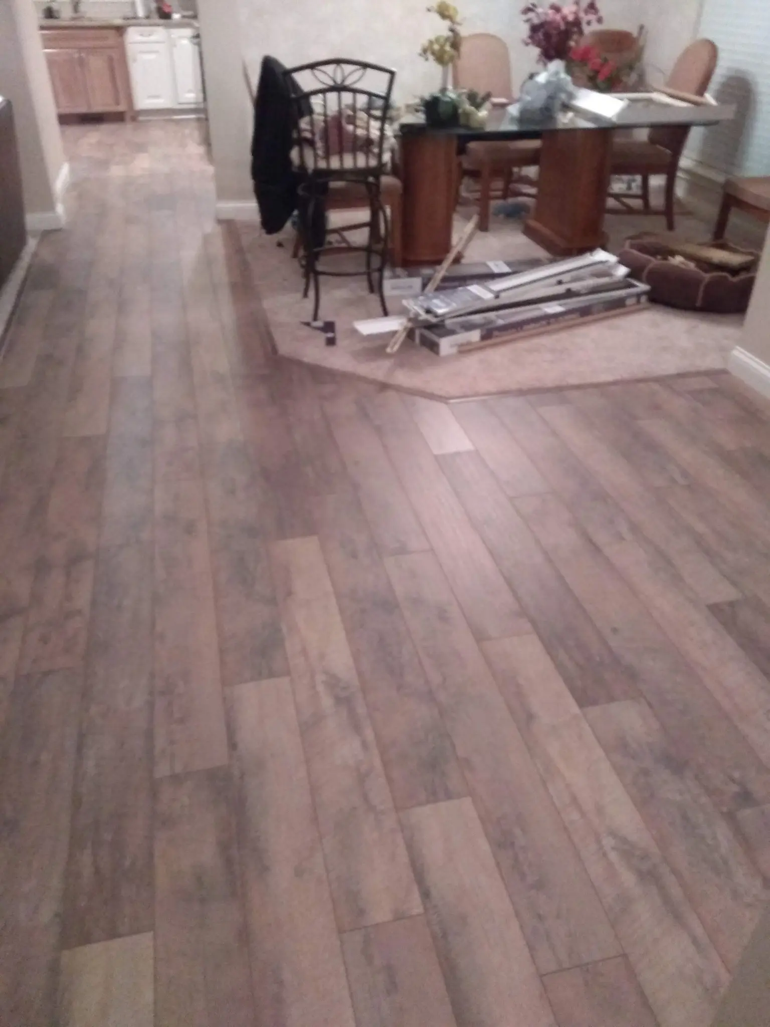 Rosewood tone laminate flooring installed in a living room